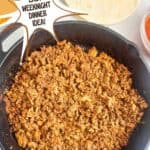 Ground chicken taco meat in a cast iron skillet. Text reads: ground chicken taco meat, easy weeknight dinner idea, www.seasonedsprinkles.com