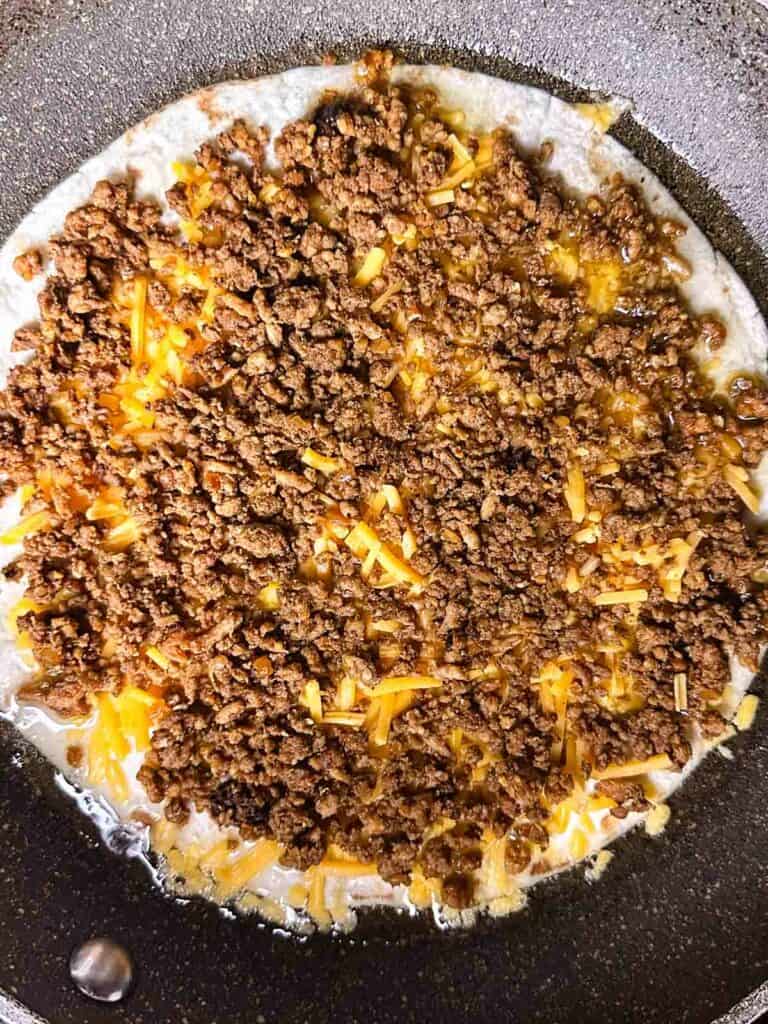 Add the chicken on top of the first layer of cheese.