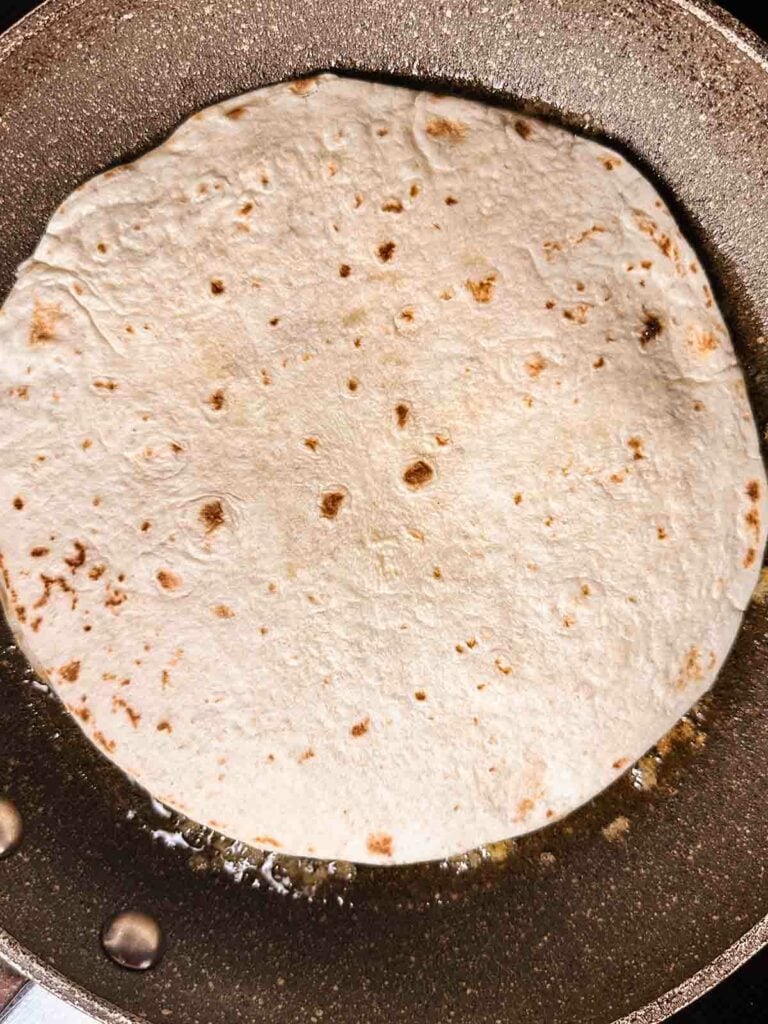 Cooking a chicken quesadilla.