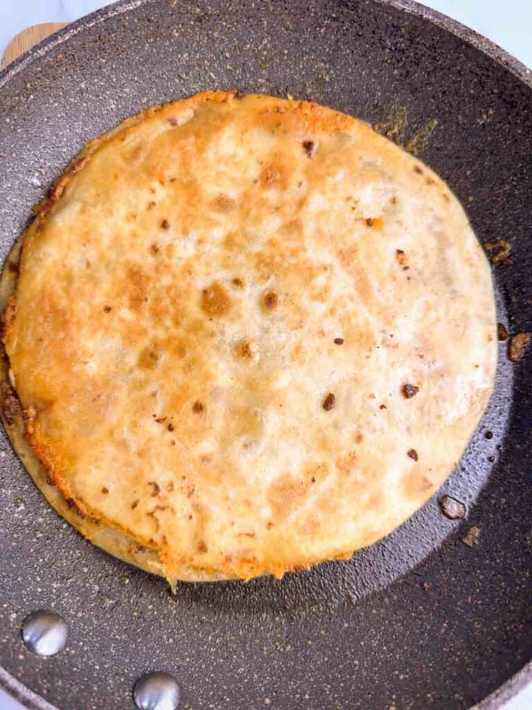 Cooking a chicken quesadilla recipe in a skillet.