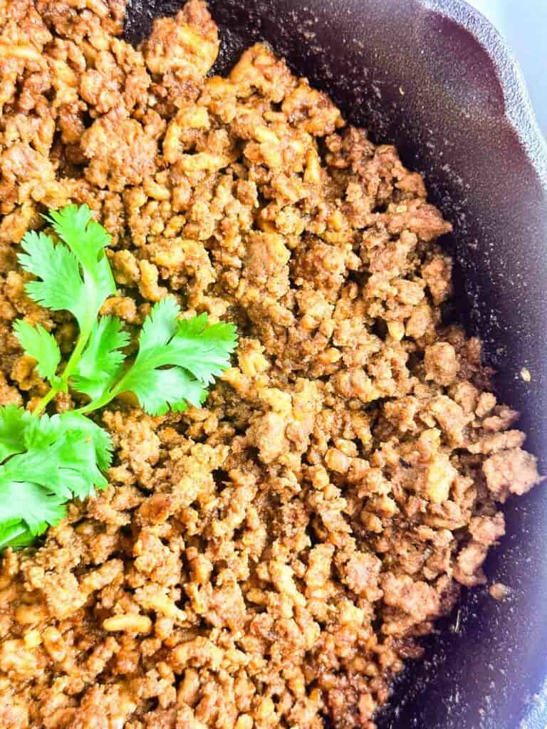Ground chicken taco meat in a cast iron skillet.