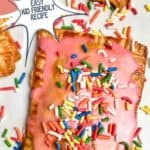 photo of Homemade Strawberry Pop Tarts with pink frosting and rainbow sprinkles with a decorative text box reading strawberry pop tarts seasonedsprinkles.com