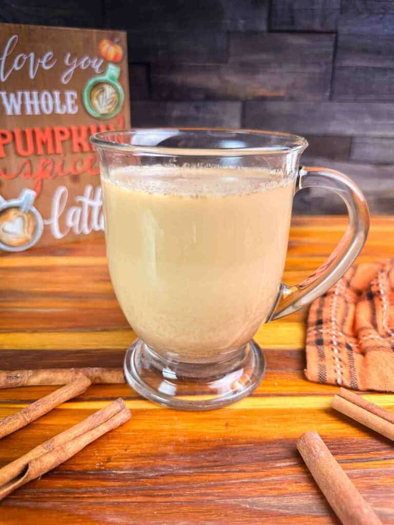 Cup of coffee with homemade pumpkin spice coffee creamer recipe in it.