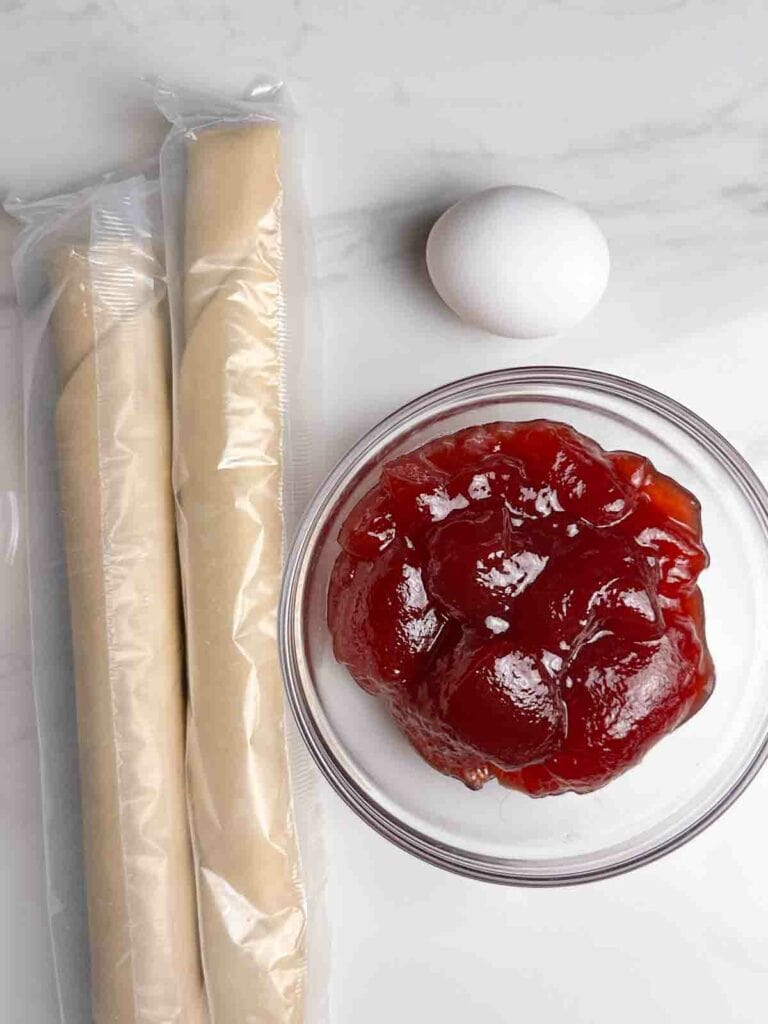 Ingredients for Homemade Strawberry Pop Tarts Recipe: Pie Crust, Strawberry Jam, and Egg