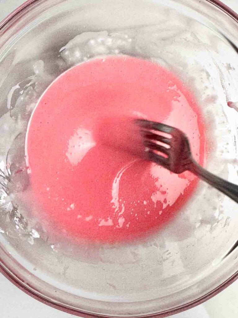 A bowl of pink icing