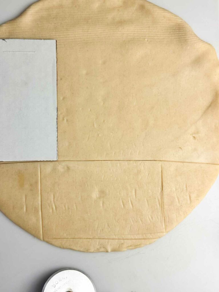 Use an index card to cut out rectangle shapes in pie crust
