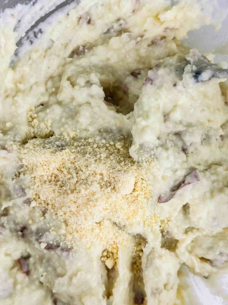 Parmesan, salt, and pepper added to red skinned potatoes mashed.