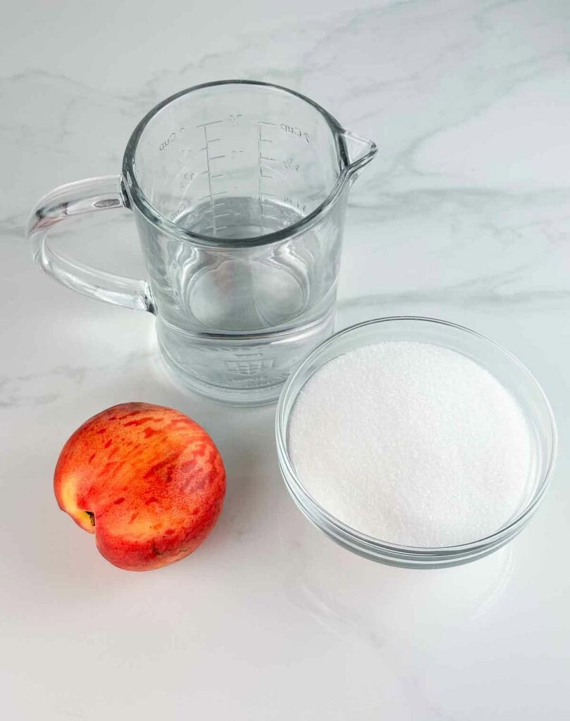 Ingredients for peach simple syrup: water, peach, and sugar.