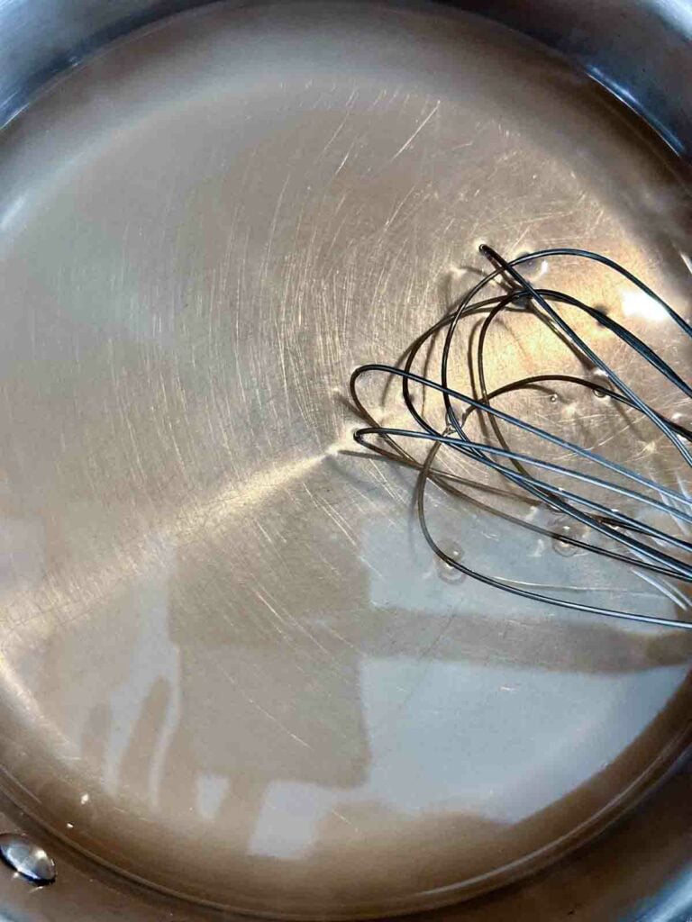 Simple syrup in metal pot.