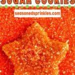 Star sugar cookie covered in and laying in orange glitter sprinkles. Text reads: orange star sugar cookies, seasonedsprinkles.com
