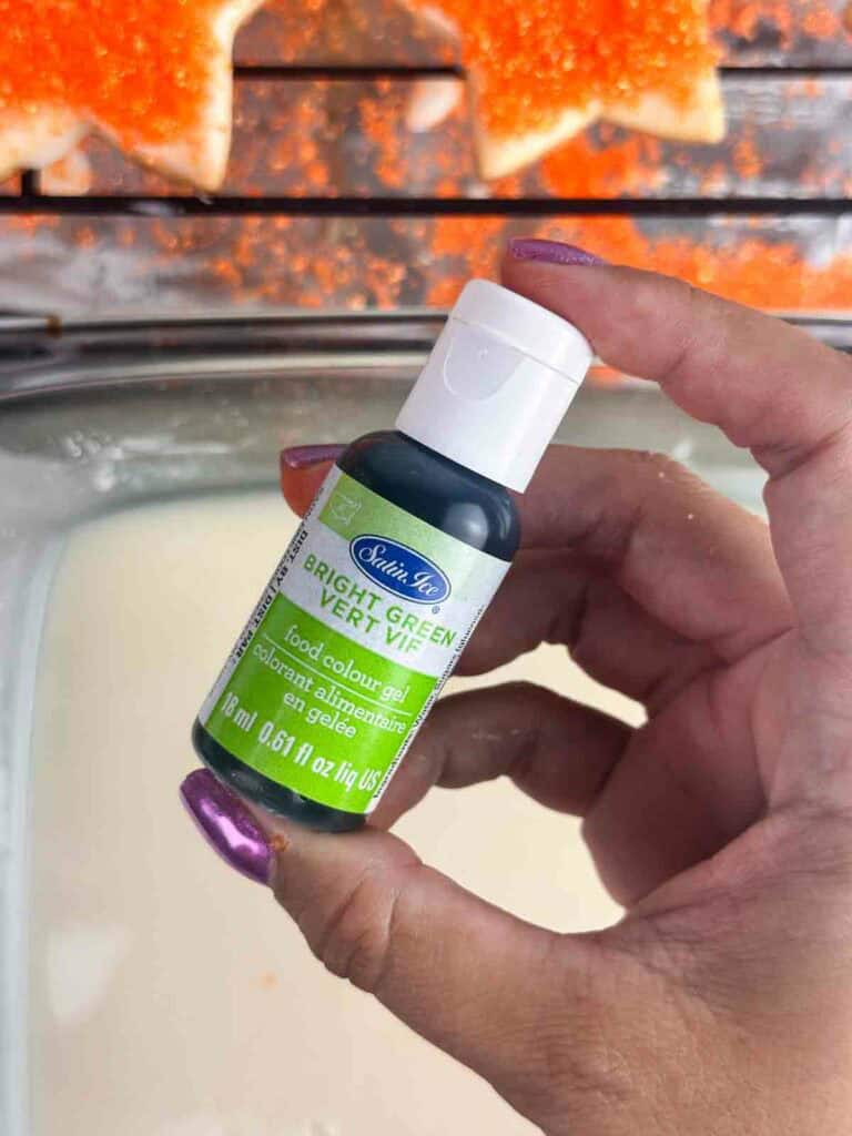 Bright green food coloring being held up.