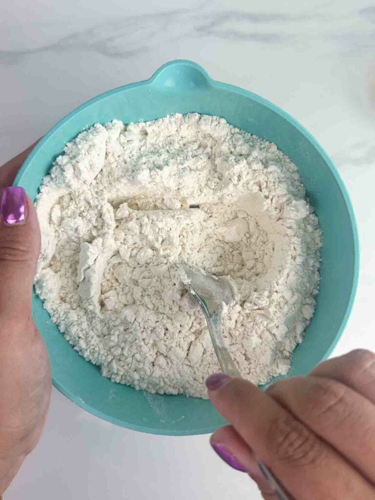 Using a fork to mix together flour and other dry ingredients.