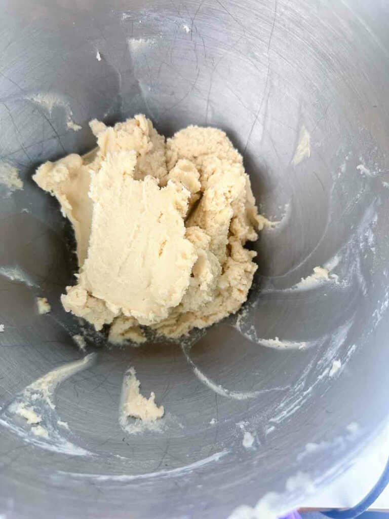 Star sugar cookie dough in the bowl of a mixer.