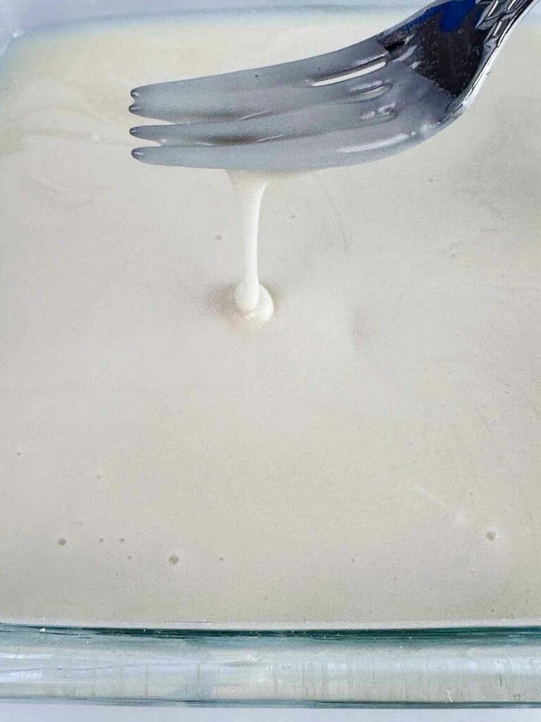 Fork coming out of a just mixed icing.