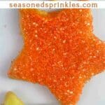 Star shaped sugar cookies with orange glitter sprinkles and green icing. Text reads: TS12, sugar cookies, seasonedsprinkles.com