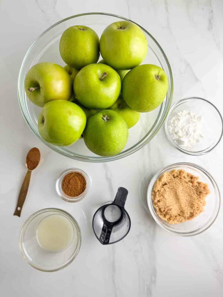 Ingredients for apple pie filling: Granny Smith apples, corn starch, cinnamon, apple pie seasoning mix, brown sugar, lemon juice, and water.