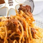 Homemade meat sauce lifted with a fork. Text reads: homemade meat sauce, quick dinner idea, www.seasonedsprinkles.com