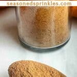 Pumpkin pie spice in a jar and spoon. Text reads: homemade pumpkin pie spice, seasonedsprinkles.com