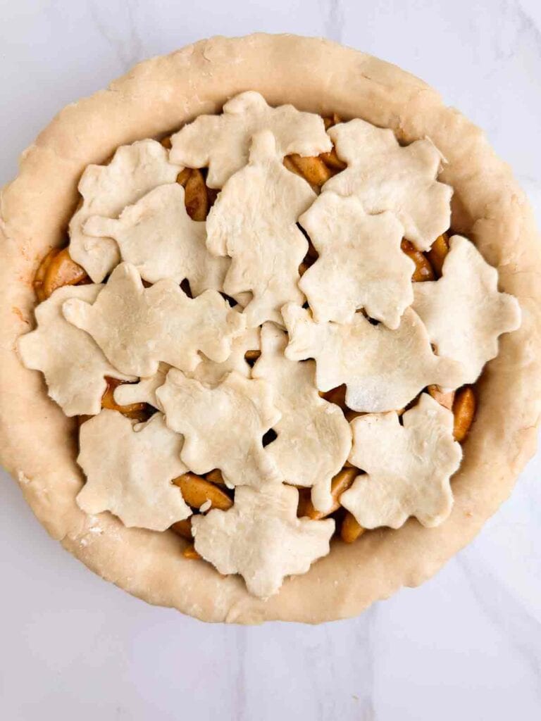 Apple pie topped with leaf covering.