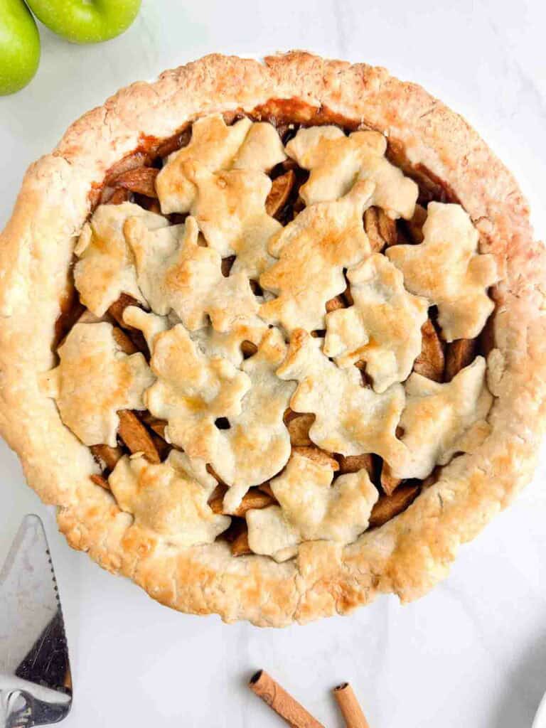 Homemade apple pie with a leaf decoration on top.