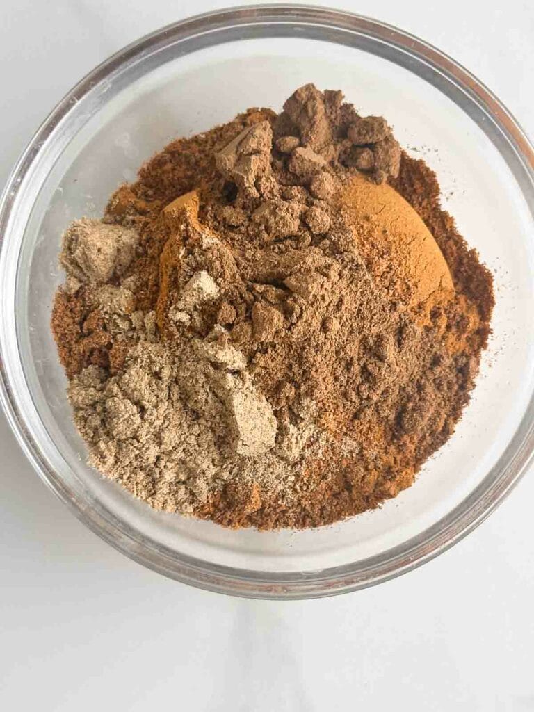 Apple pie spices in a small bowl, ready to be mixed.
