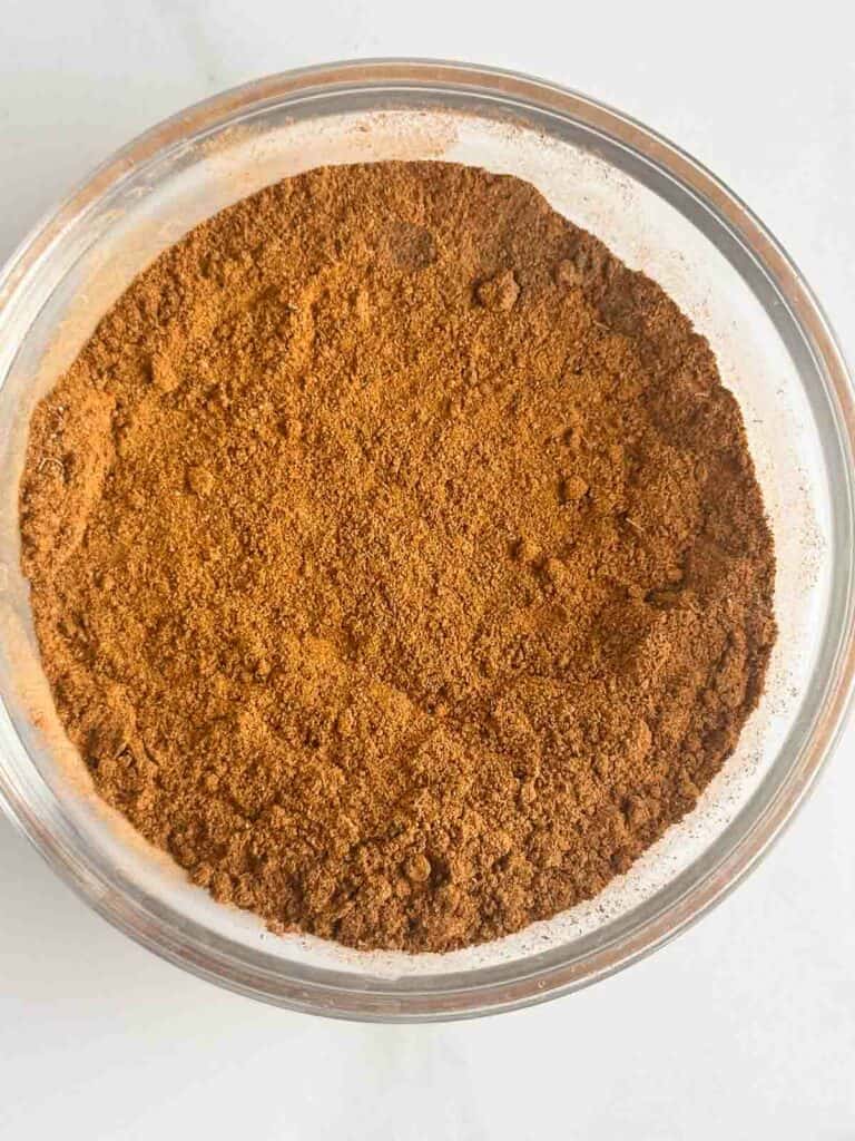 Mixed apple pie spice in a small bowl.