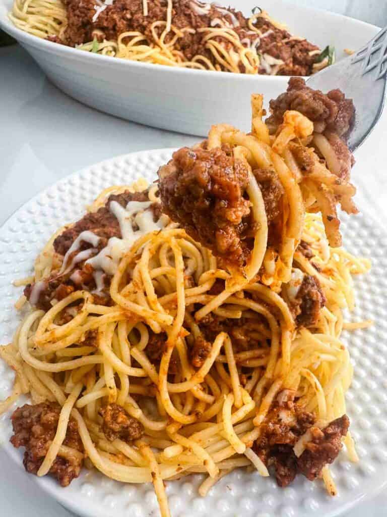 Getting a forkful of homemade meat sauce.