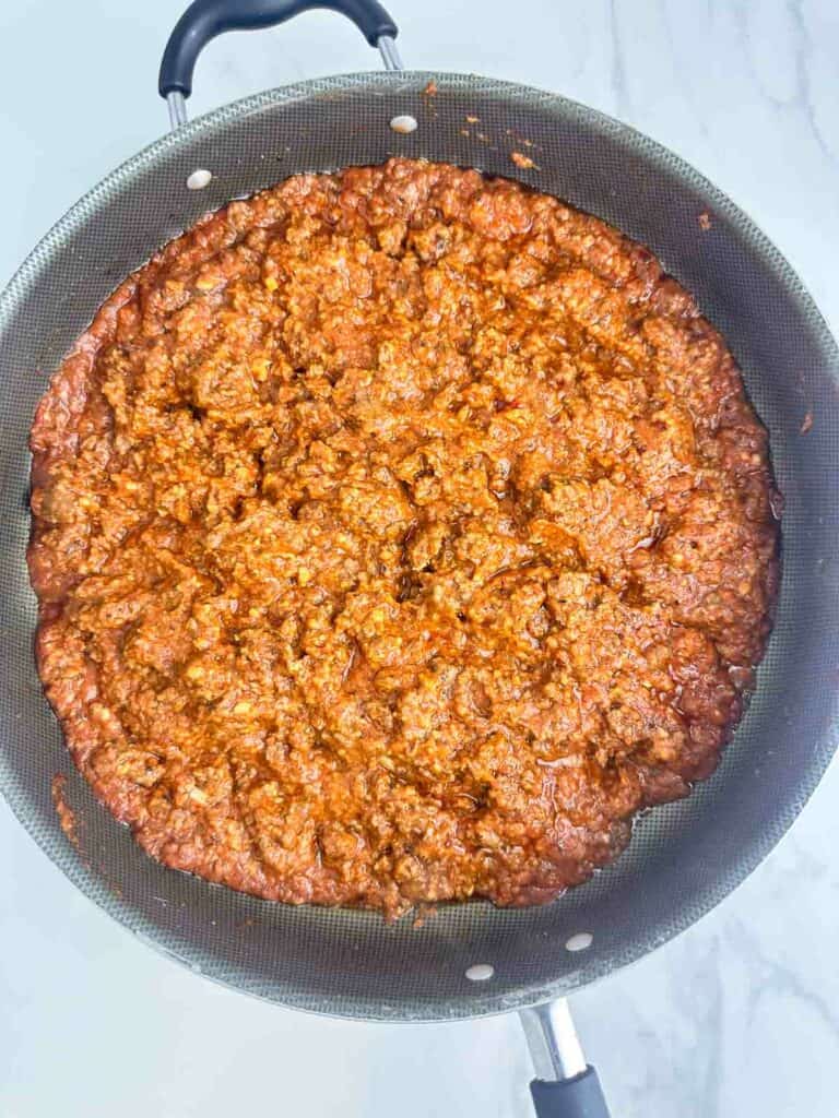 Meat sauce ready to serve on a white counter.