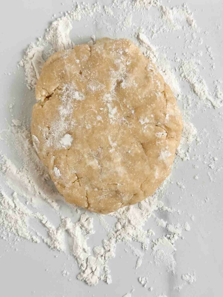 Pie dough disc ready to roll out to place in a pie baking dish.