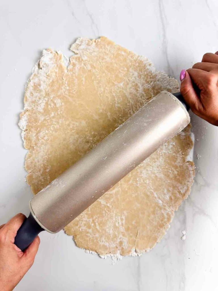 Roll out the pie dough into roughly 12 inch rough circles.