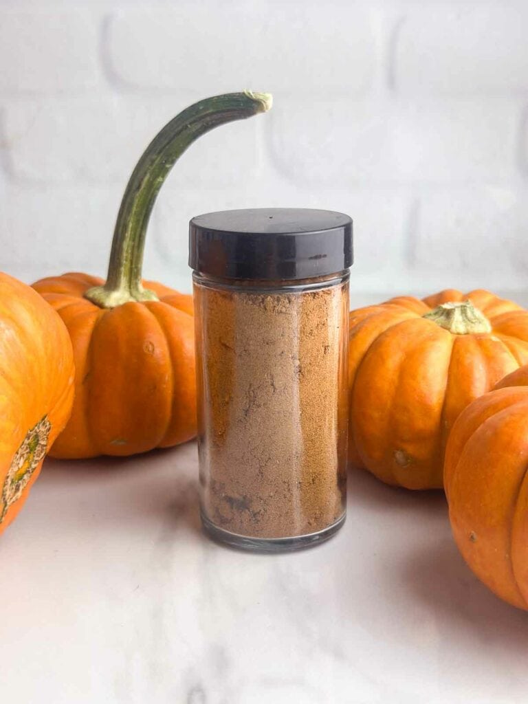 Homemade pumpkin pie spice recipe stored in a small jar.