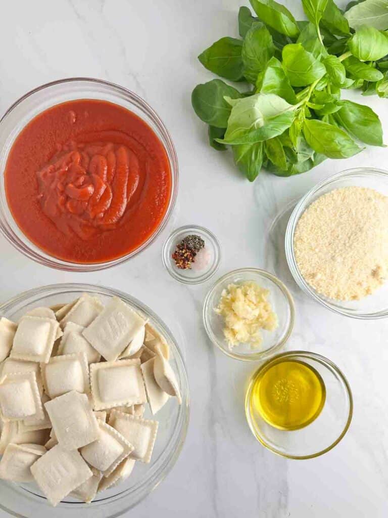 Ingredients for Ravioli with Sauce Recipe: Ravioli, Crushed Tomatoes, Olive Oil, Garlic, Parmesan Cheese, Spices, and Basil