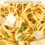 Spaghetti Aglio e Olio with basil and parmesan cheese. Text reads: spaghetti aglio e olio, seasonedsprinkles.com