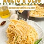 Spaghetti Aglio e Olio with basil and parmesan cheese. Text reads: spaghetti aglio e olio, seasonedsprinkles.com