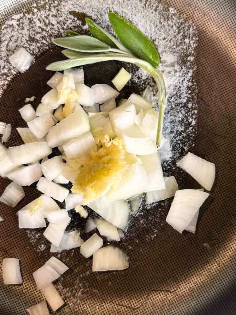 Sauteing sage, onions, and garlic in butter.