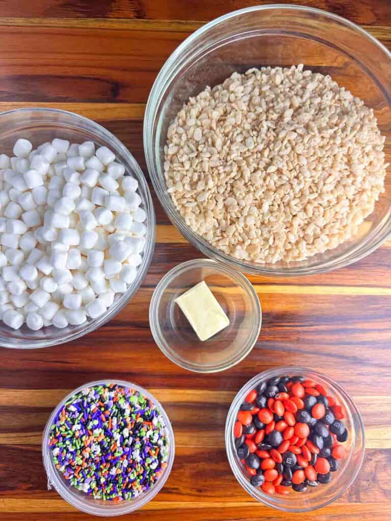 Ingredients for Halloween Rice Krispie Treats: Rice Krispies, marshmallows, butter, Halloween sprinkles, and M&Ms.