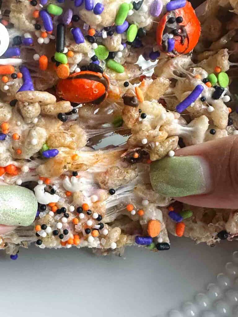 Pulling apart a Halloween rice krispie treat.
