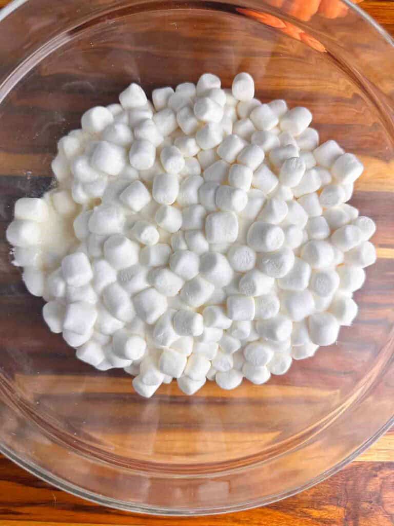 Marshmallows ready to mix into a paste in clear bowl.