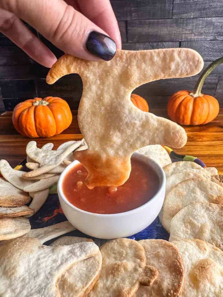 Halloween tortilla chip dipped in salsa