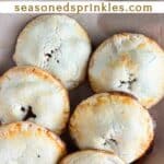 Baked mini apple pies on a tray. Text reads: mini apple pies, seasonedsprinkles.com