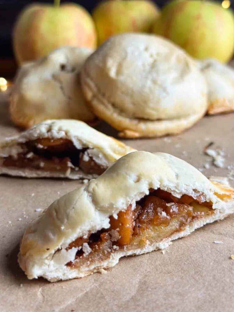 Mini apple pie sliced in half.