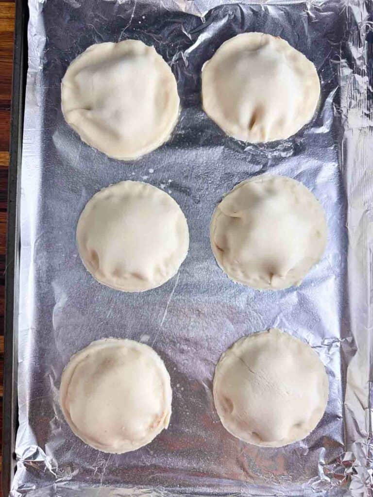 Mini apple pies that still need holes for steam.