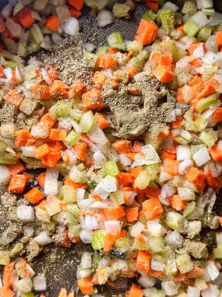 Adding the seasoning to the miroux poix for the sourdough stuffing.