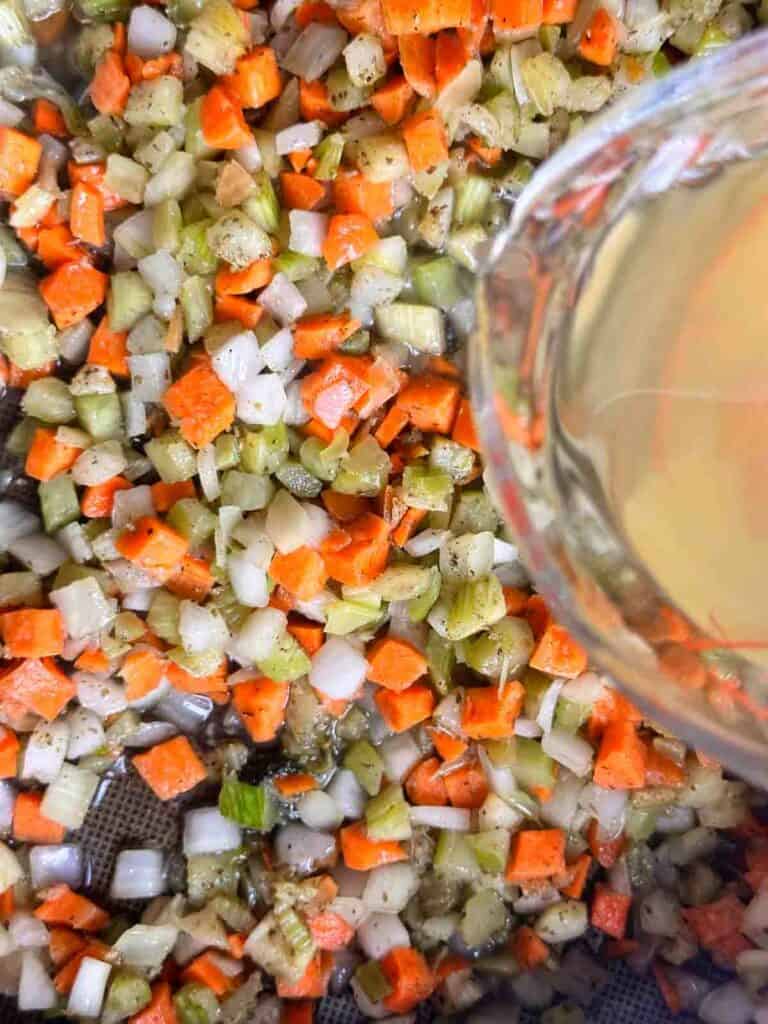 Adding a little bit of broth to miroux poix.