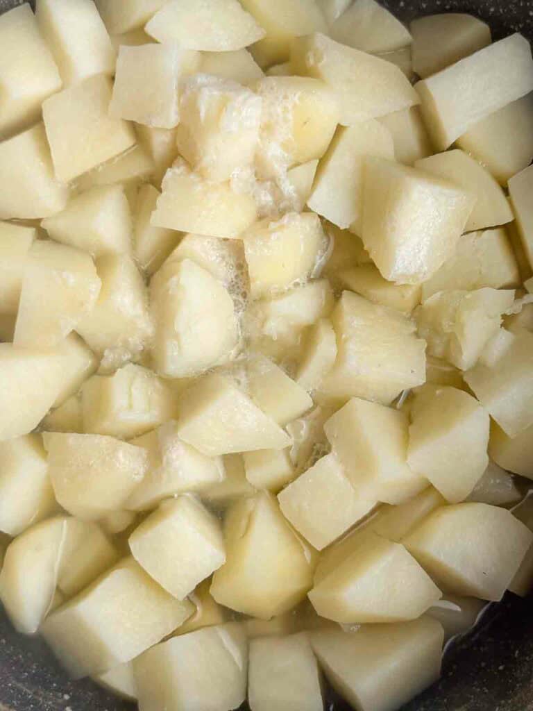 Freshly boiled potatoes to make cheesy mashed potatoes.