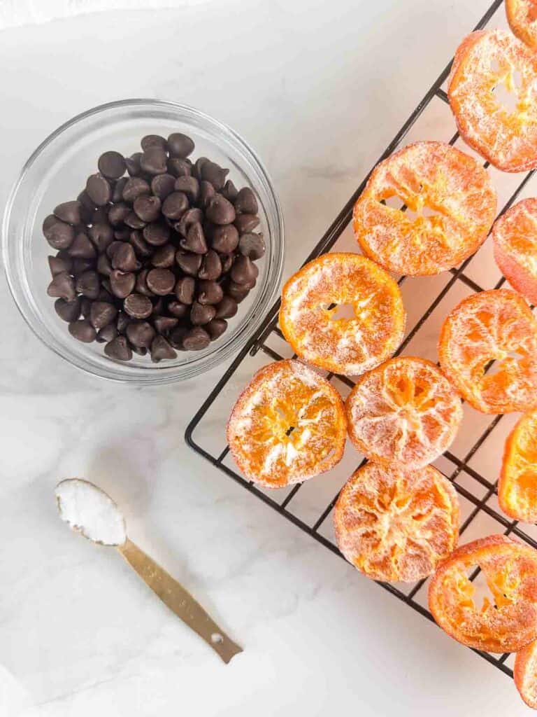 Ingredients for chocolate dipped orange slices: candied oranges, chocolate chips, and coconut oil.