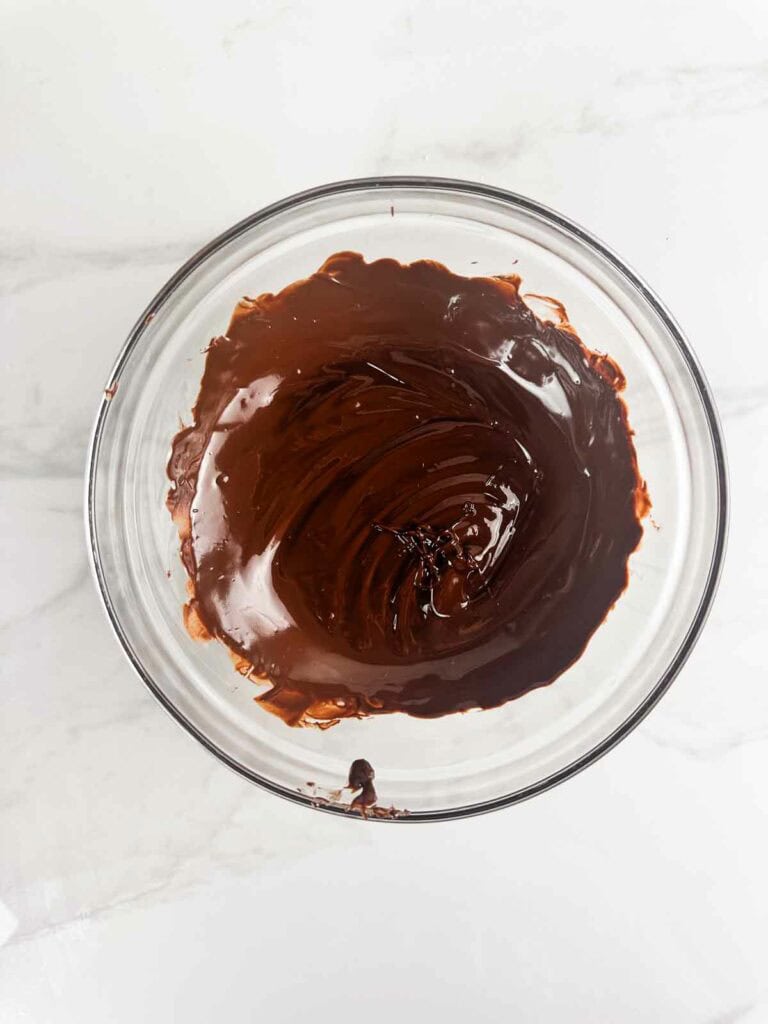 Melted chocolate in a clear bowl.