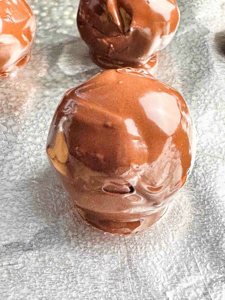 Freshly dipped chocolate peanut butter ball.