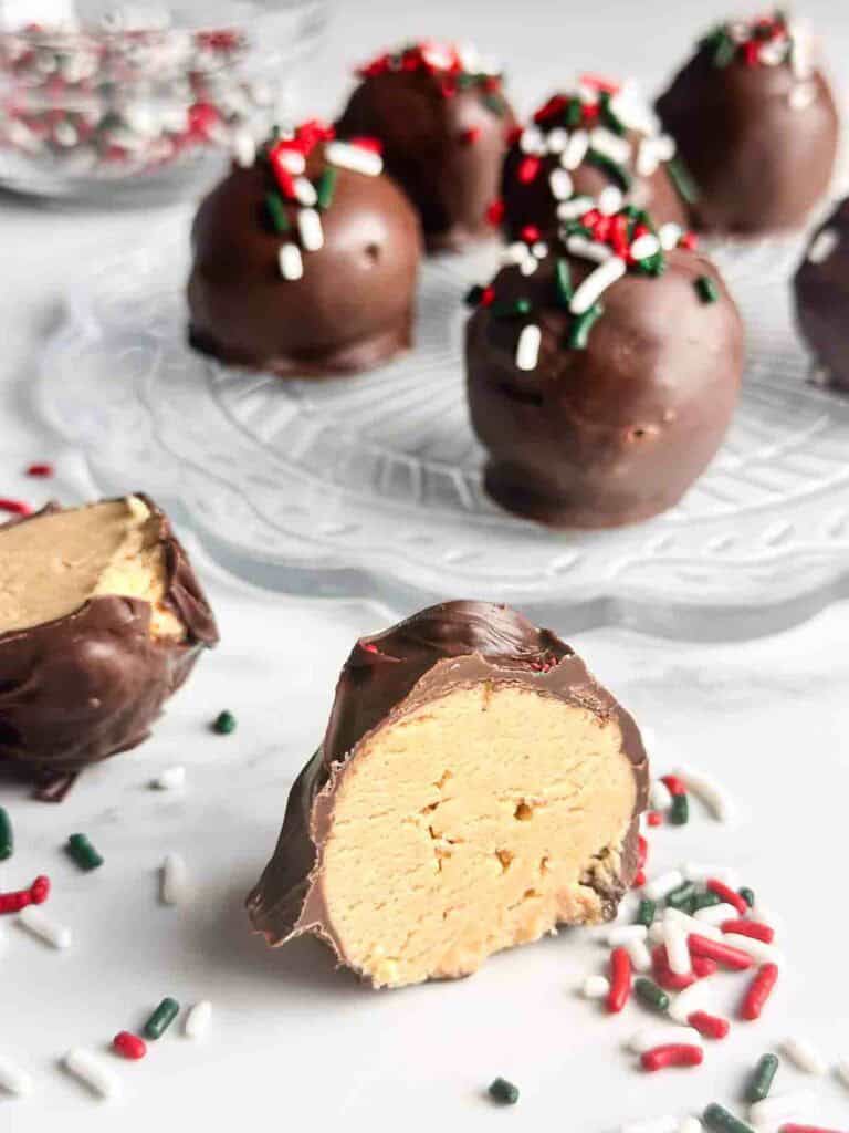 Chocolate peanut butter ball cut in half with others in the background.