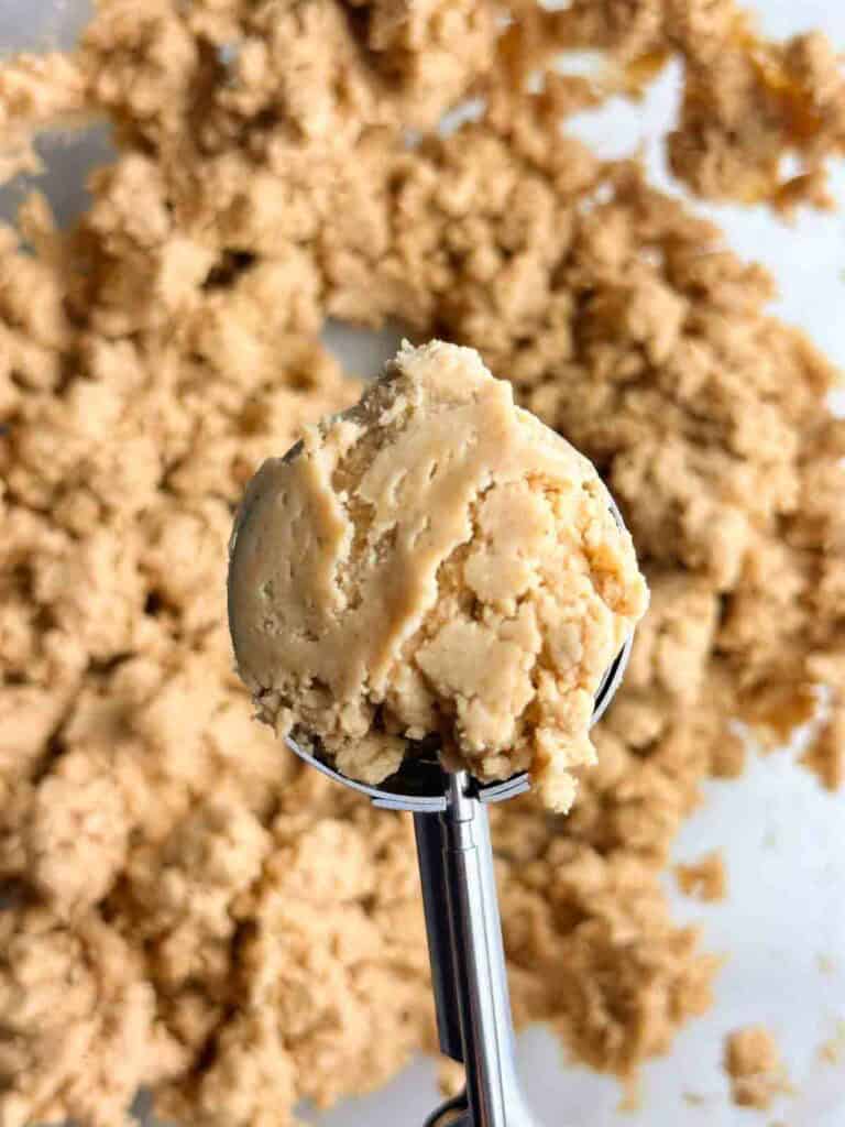 Using a melon baller or ice cream scoop to get consistent sized peanut butter balls for dipping in chocolate.